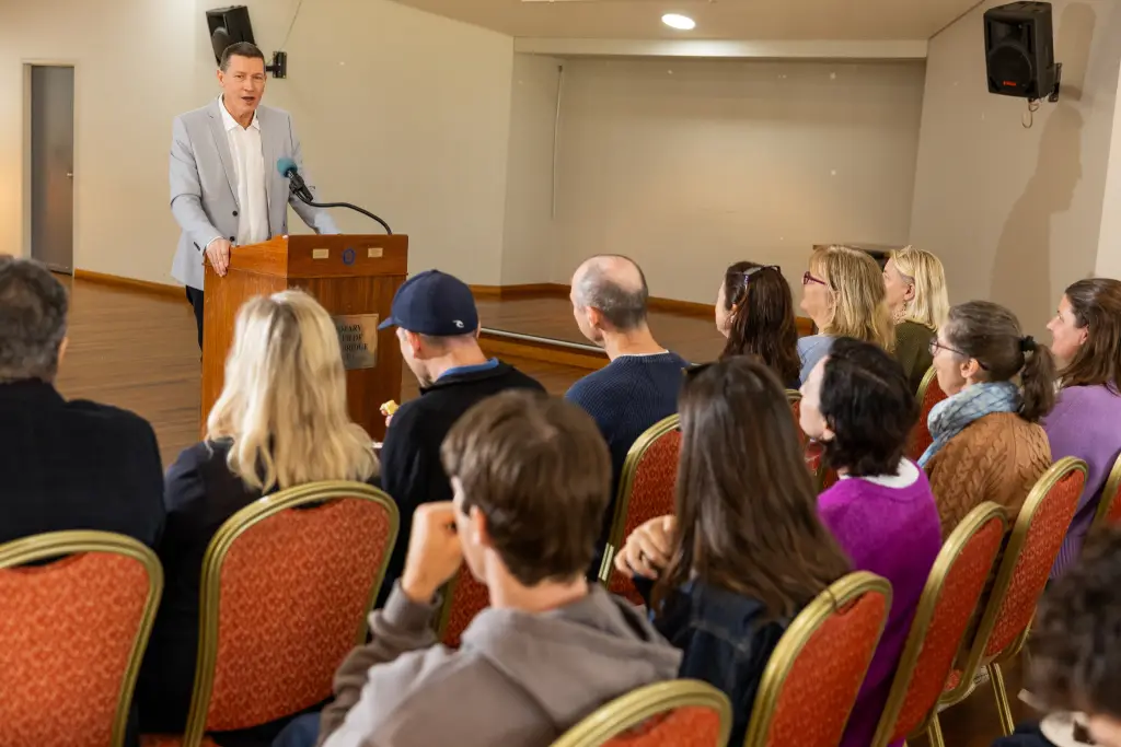 michael speaking to a group of people from podium